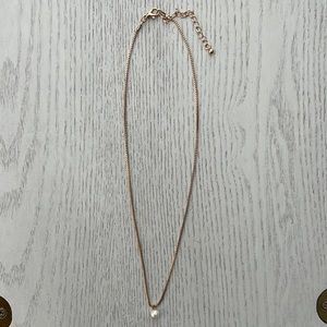 Gold necklace with a single pearl pendant